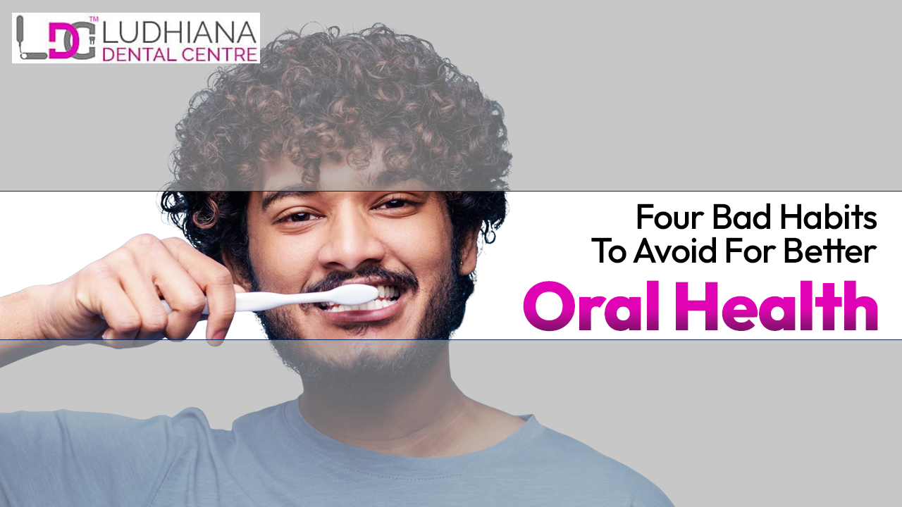 A man smiling while brushing his teeth